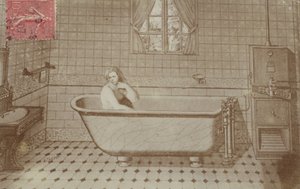 A woman in the bath in a bathroom by French School