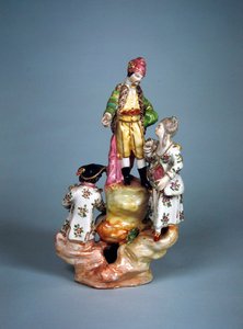 Statuette of four persons grouped on a rockery
