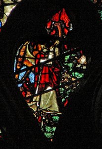 The west rose window depicting a scene from the Book of Revelation: Sounding of the first trumpet. Hail and fire descend