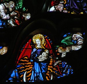 The west rose window depicting a scene from the Book of Revelation: Woman clothed as the sun, the moon under her feet and twelve stars in her nimbus by French School