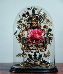 Wedding wreath of orange blossom under a globe