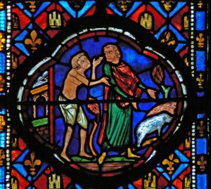 Window Ew-L depicting a scene from the Prodigal Son story: having spent all his money he looks after pigs and reflects on his situation