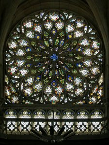 Window S rose depicting the south rose window, built in the early C16, contains much of its original decorative glass, though it was much restored in 1865