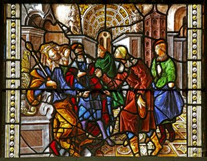Window depicting St Thomas in India is invited to the wedding of Pelagius, is beaten by a servant who is in turn eaten by a lion. A dog brings in the servant