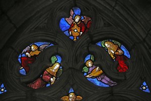 Window depicting angel musicians and the Host by French School