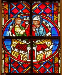 Window depicting St Denis receives communion in prison