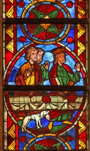 Window w213 depicting a scene from the life of St Thomas: at the banquet a dog brings in the cupbearer