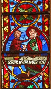 Window w213 depicting a scene from the life of St Thomas: the saint at a marriage banquet for the daughter of the king of India has his face slapped by a cupbearer by French School