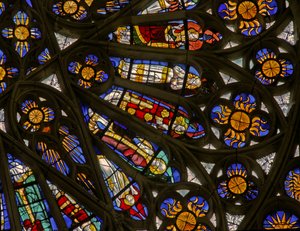 Window depicting suns and bishops beneath the Angelic Hierarchy in the north rose window by French School
