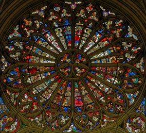 Window, the north rose window, depicting the Coronation of the Virgin in the two uppermost openings, surrounded by angels carrying musical instruments and the Instruments of the Passion