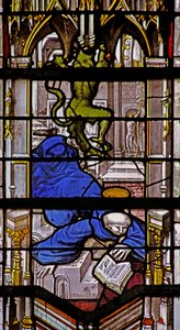 Window depicting St Martin falls downstairs: a devil celebrates