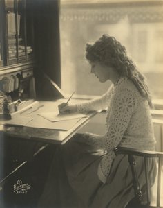 Mary Pickford writing at a desk
