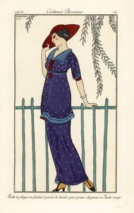 Woman in beach dress of foulard decorated with large dots, red suede hat