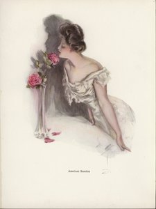 American woman smelling pink roses in a vase