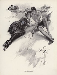 Two lovers drawing hearts in the sand at the beach