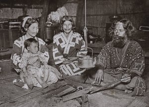 Ainu Man and Women at Home by Herbert Ponting