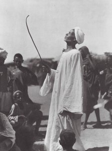 Africa: Old man mocking the dancer by Hugo Adolf Bernatzik