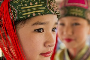 Portrait of a young girl wearing Deel, Mongolian traditional clothing at Naadam