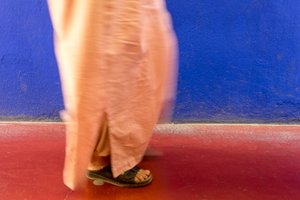 Walking past a blue wall in the Majorelle Garden, Marrakech, Morocco