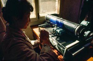 In the commune office a member types on a Chinese typewriter, Chun Xing Commune, Yunnan