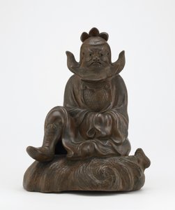 Figure of Shoki, the demon queller, seated on a rock, Edo period or Meiji era by Japanese School