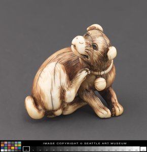Netsuke modeled as a dog scratching its neck