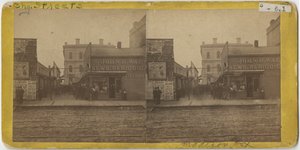 View of John R. Walsh Periodicals store on Madison Street, Chicago with the Post Office in the background, 1869
