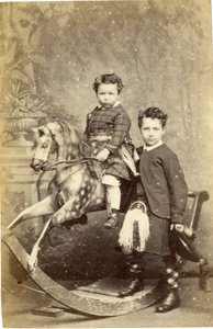 Young Girl on Rocking Horse with Young Boy in Kilt Standing, 1860s