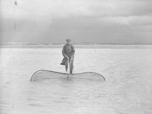 Fisherman Using a Large Net in Shallow Water by Joseph Hardman