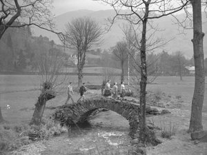 Group of young walkers walking over bridge by Joseph Hardman