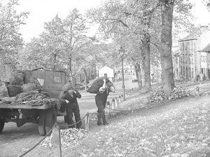 Lorry on Street with Two Coalmen Carrying Sacks of Coal