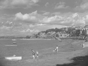 People playing in boats at high water in Arnside with Albion Hotel in background by Joseph Hardman