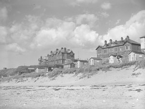 View from Silloth beach of beach huts and houses along seafront by Joseph Hardman