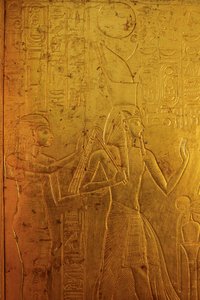 Gold shrine surrounding sarcophagus depicts Goddess Isis by Kenneth Garrett