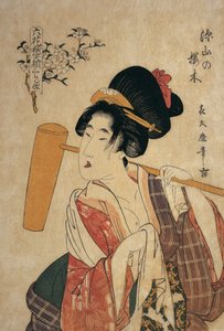 Close-up of a young woman with a wooden pestle on her shoulder