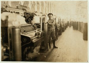 Boy sweeper by carding machines at Lincoln Cotton Mills, Evansville, Indiana in stockinged feet on a slippery floor, 1908 by Lewis Wickes Hine
