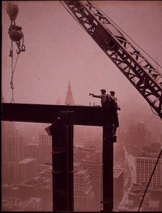 Empire State Building under construction, showing placing of steel girder