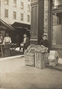 Lena Lochiavo - 11 years old, basket (and pretzel) seller, at Sixth Street Market in front of saloon entrance, Cincinnati, Ohio by Lewis Wickes Hine