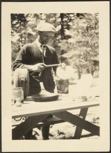 Man Standing at Picnic Table by Louis Fleckenstein