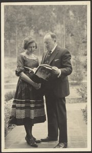 Man and Woman Standing Outside with Magazine by Louis Fleckenstein