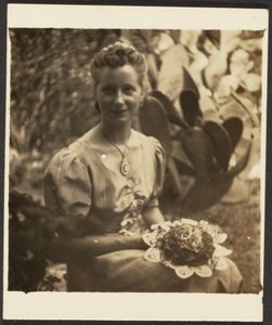 Woman Holding Bouquet Sitting before Cactus