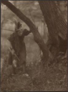 [Woman in Head Dress Behind Tree] by Louis Fleckenstein