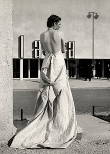 Model seen from the back wears an evening dress created by the couture house "Lamma"