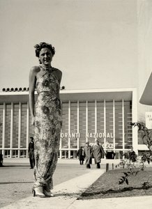 Model wears a long dress with a floral pattern, created by the couture house Graldi