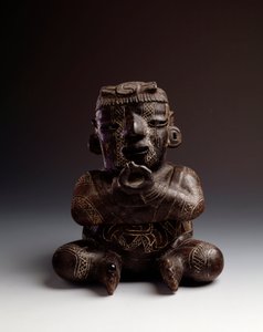 Anthropomorphic clay vase depicting a man seated with hands joined in the shape of a circle