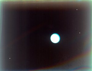 Uranus with satellites Miranda, Ariel and Umbriel, from Voyager 2, 24 January 1986 by NASA Images