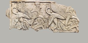 Furniture plaque carved in relief with two falcon-headed sphinxes trampling captives