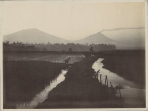Man Working on the Land at the Foot of a Smoking Volcano by Onnes Kurkdjian