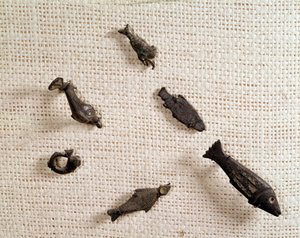 Christian antiquity: fibulae and metal jewelry in the shape of fish. National Museum of Archeology, Saint Germain en Laye by Paleo Christian Paleo Christian