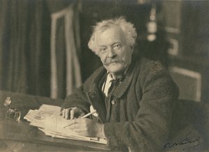 Félix Nadar seated at writing table by Paul Nadar